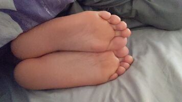 Playing with her feet while she's sleeping